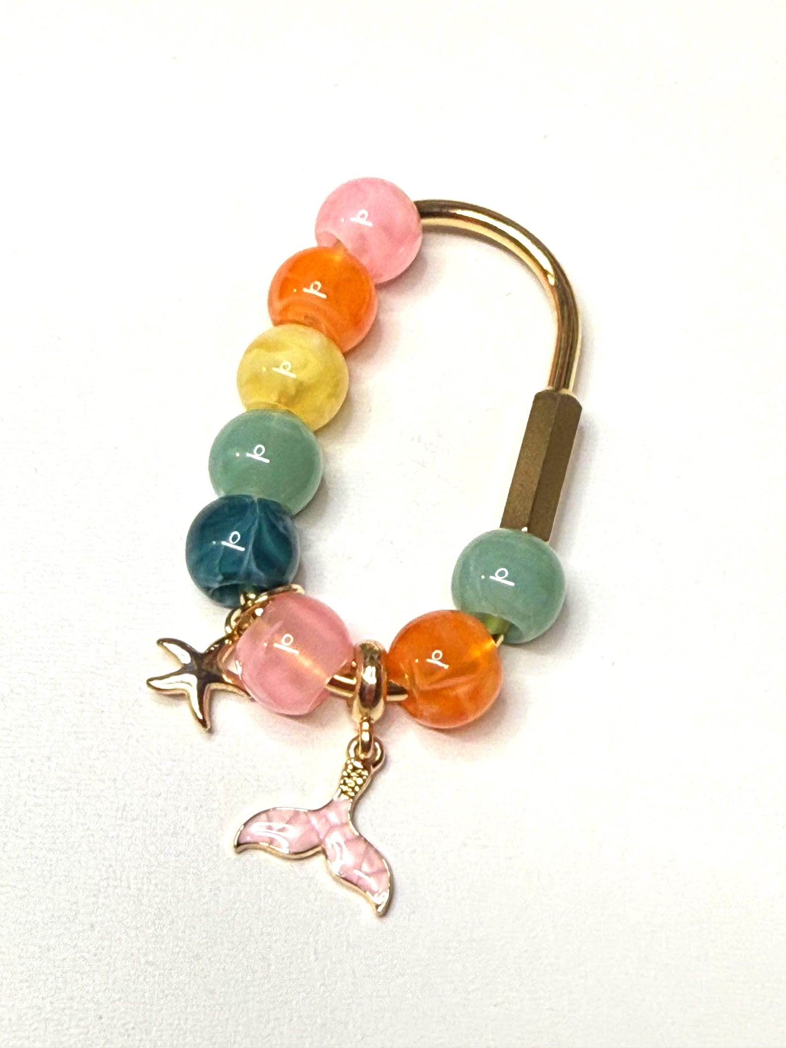 Beaded carabiner bag charm with pink and gold beads and a gold starfish charm