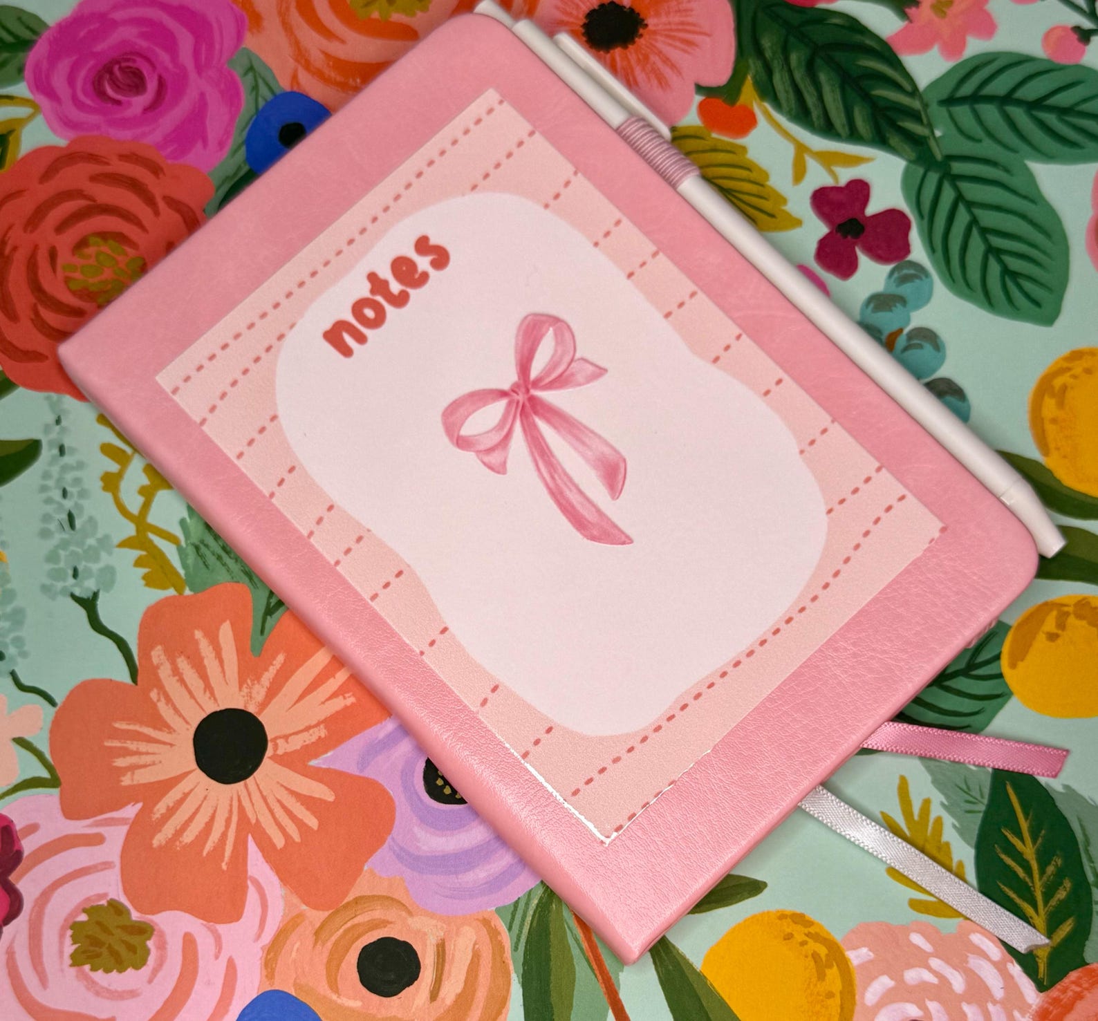 Hardcover notebook and pen set with a pink bow design